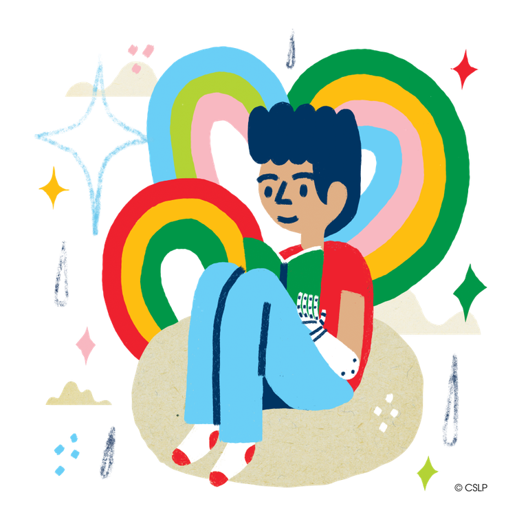 boy reading on a beanbag chair with rainbows and diamond shapes behind him